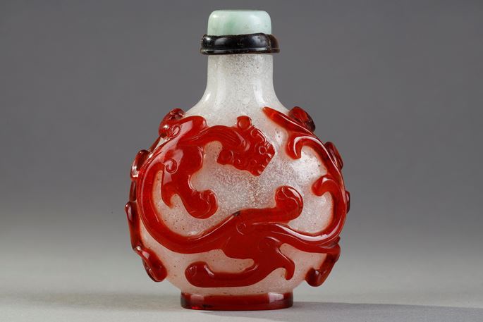 Beautiful red glass snuffbottle overlay on bully background adorned on each side of a dragon shi China 1750/1820 | MasterArt
